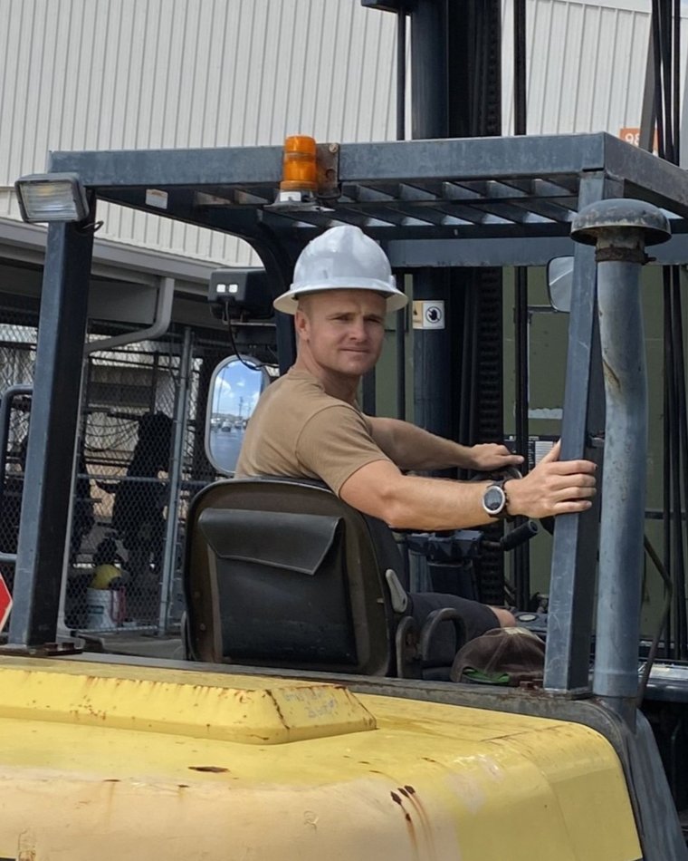 Nolan on a forklift overseas